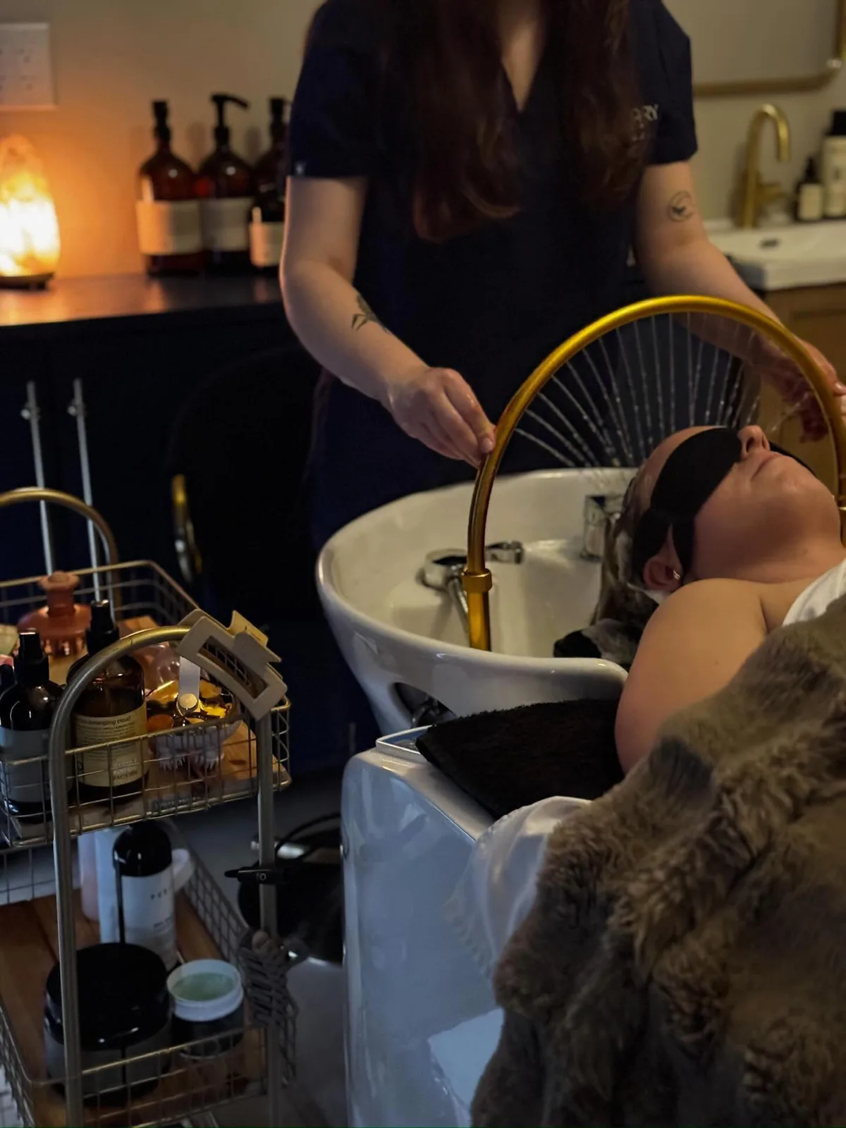 A Sanctuary practitioner preparing a scalp ritual inside the Fairfield studio