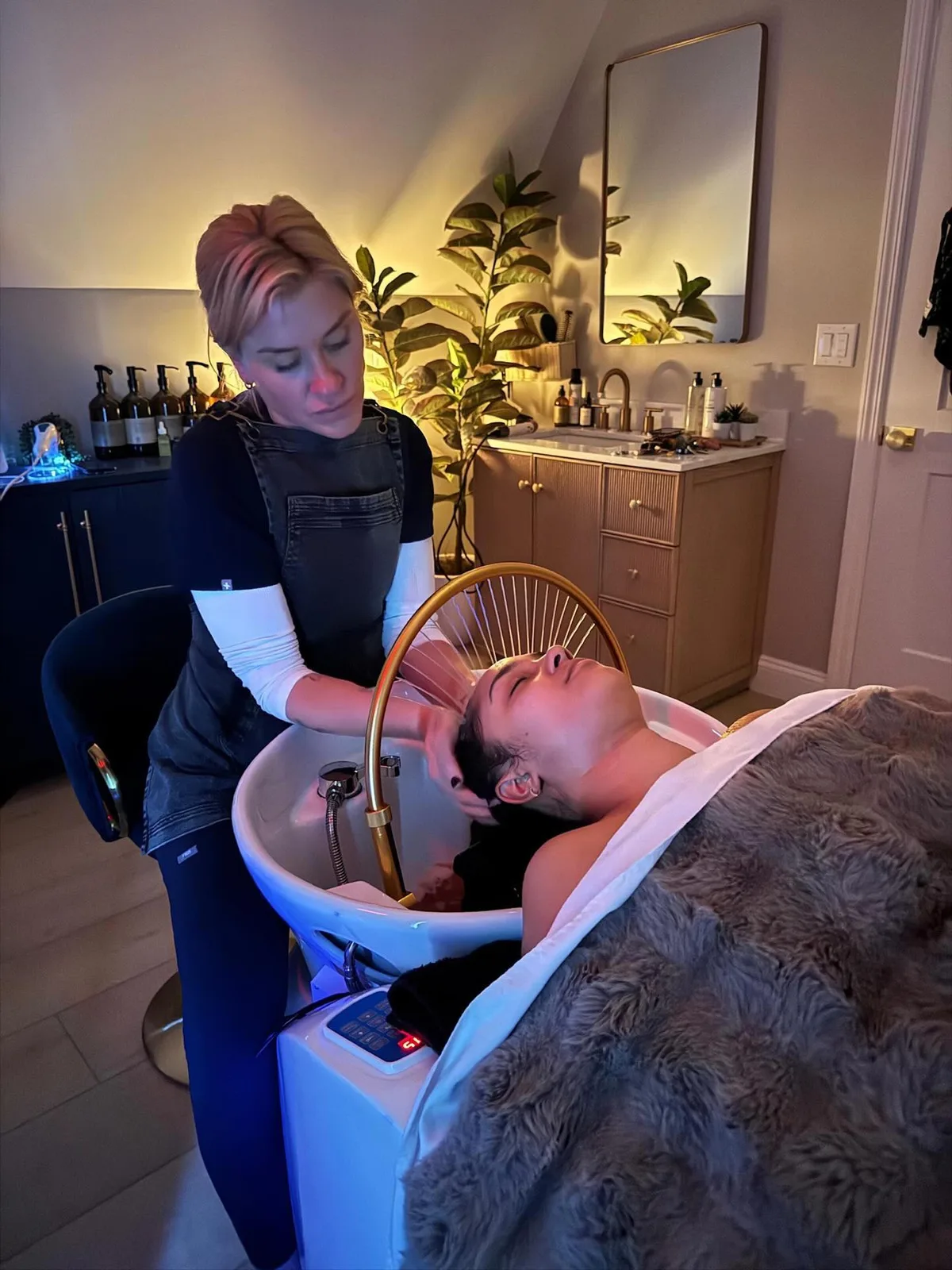 Sanctuary practitioner performing a scalp ritual in the treatment room